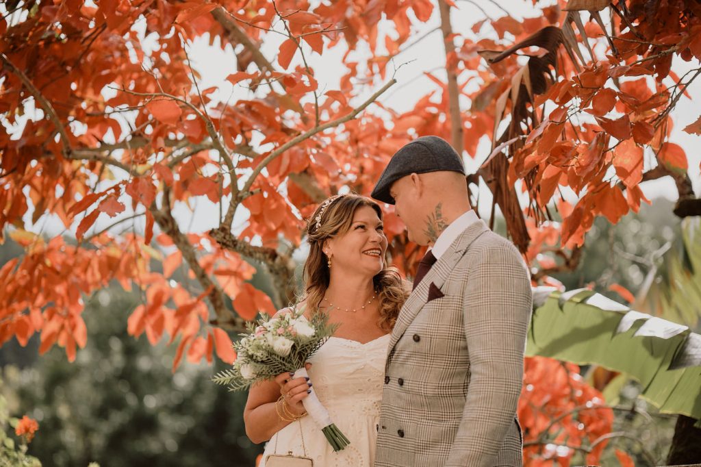 Couple in Monserrate, Sintra with red autumn leaves on the back