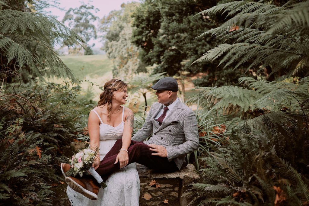 Couple sitting in Monserrate, groom has his legs over the bride's lap