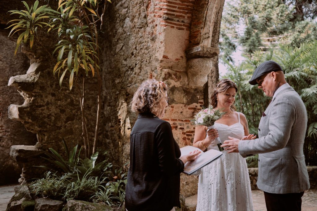 Wedding celebrant with couple eloping in the ruins of church in Monserrate, Sintra