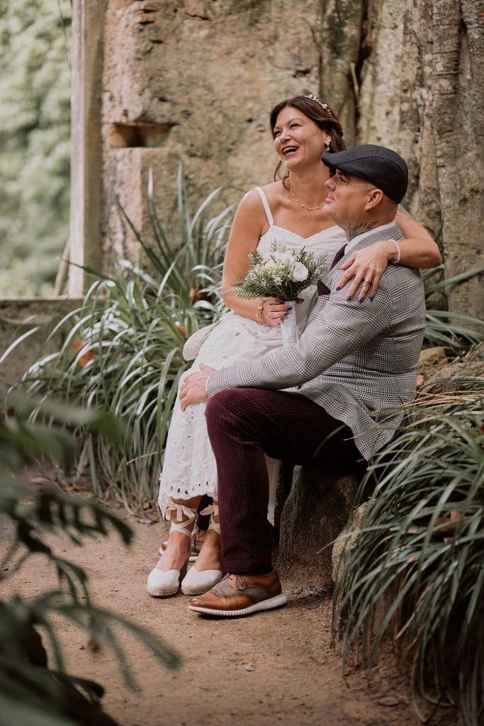 Couple sitting in the ruins of church in Monserrate, Sintra